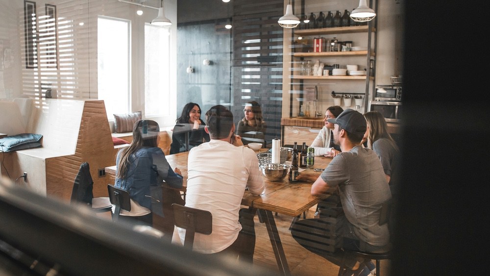 A team meeting around a long wooden table